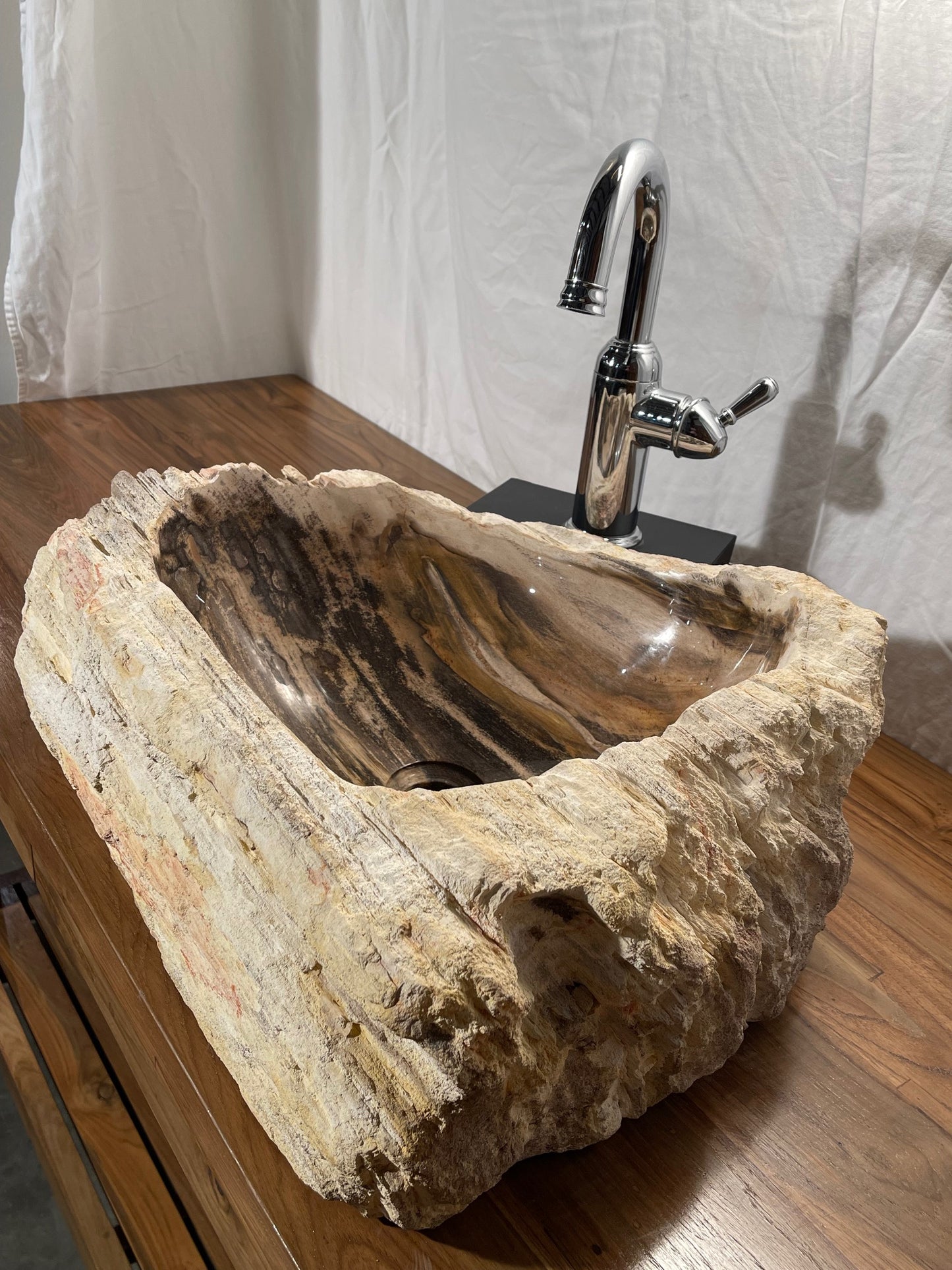 Petrified wood stone vessel sink with mixed natural colors at impact imports in boise idaho