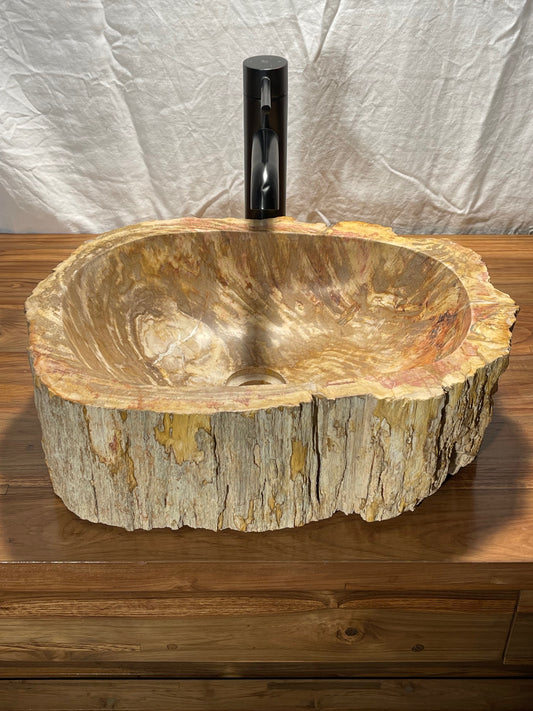 Log shaped petrified wood stone vessel sink with a textured but smooth brown exterior color at impact imports of Boise, Idaho