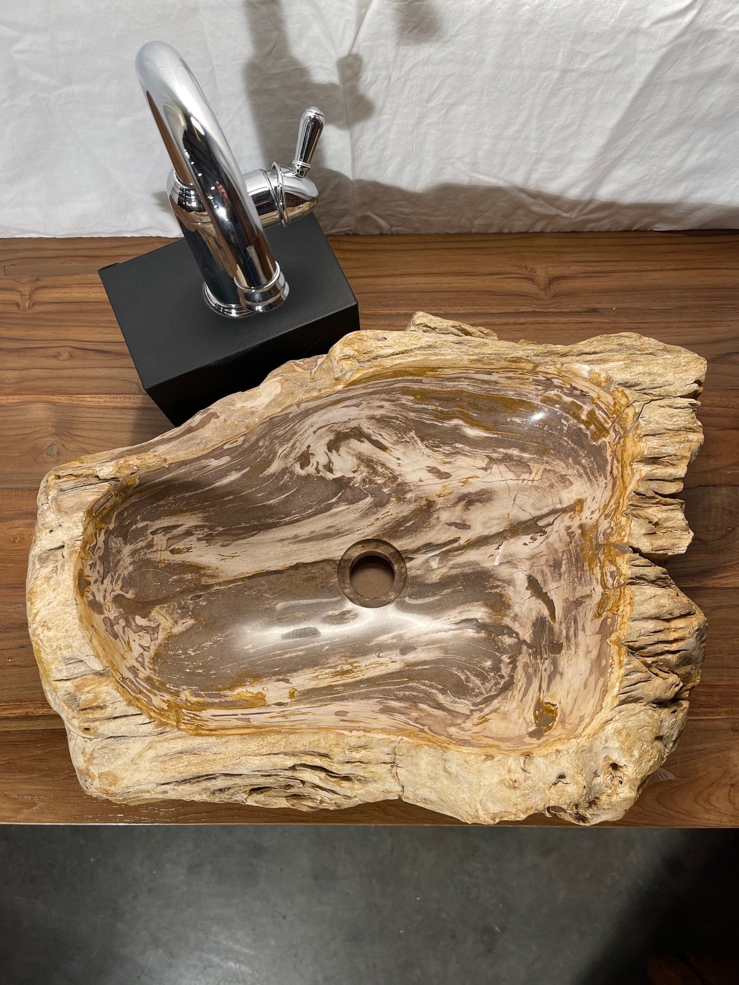 Brown color petrified wood stone vessel sink with log-like appearance at impact imports in boise idaho