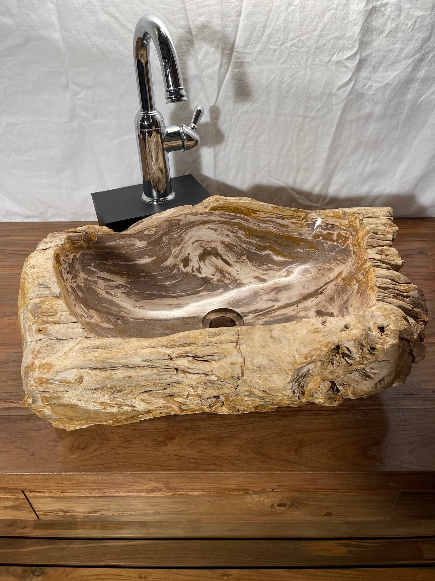 Brown color petrified wood stone vessel sink with log-like appearance at impact imports in boise idaho