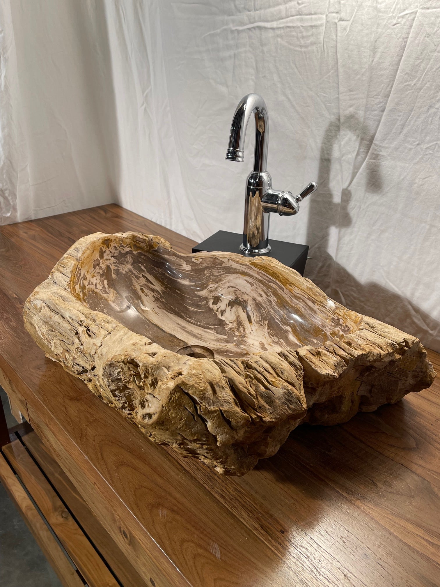 Brown color petrified wood stone vessel sink with log-like appearance at impact imports in boise idaho