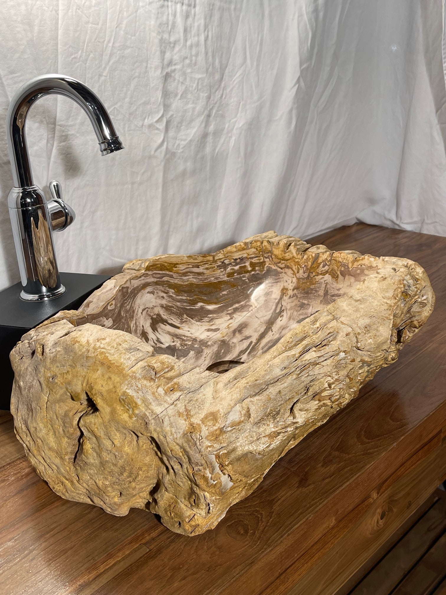 Brown color petrified wood stone vessel sink with log-like appearance at impact imports in boise idaho