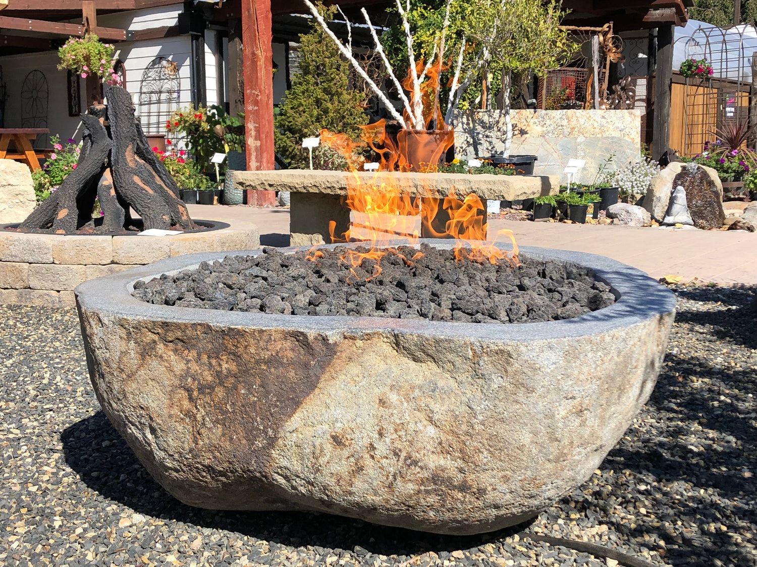 Natural river rock boulder stone gas burning outdoor fire pit from Impact Imports in Boise Idaho