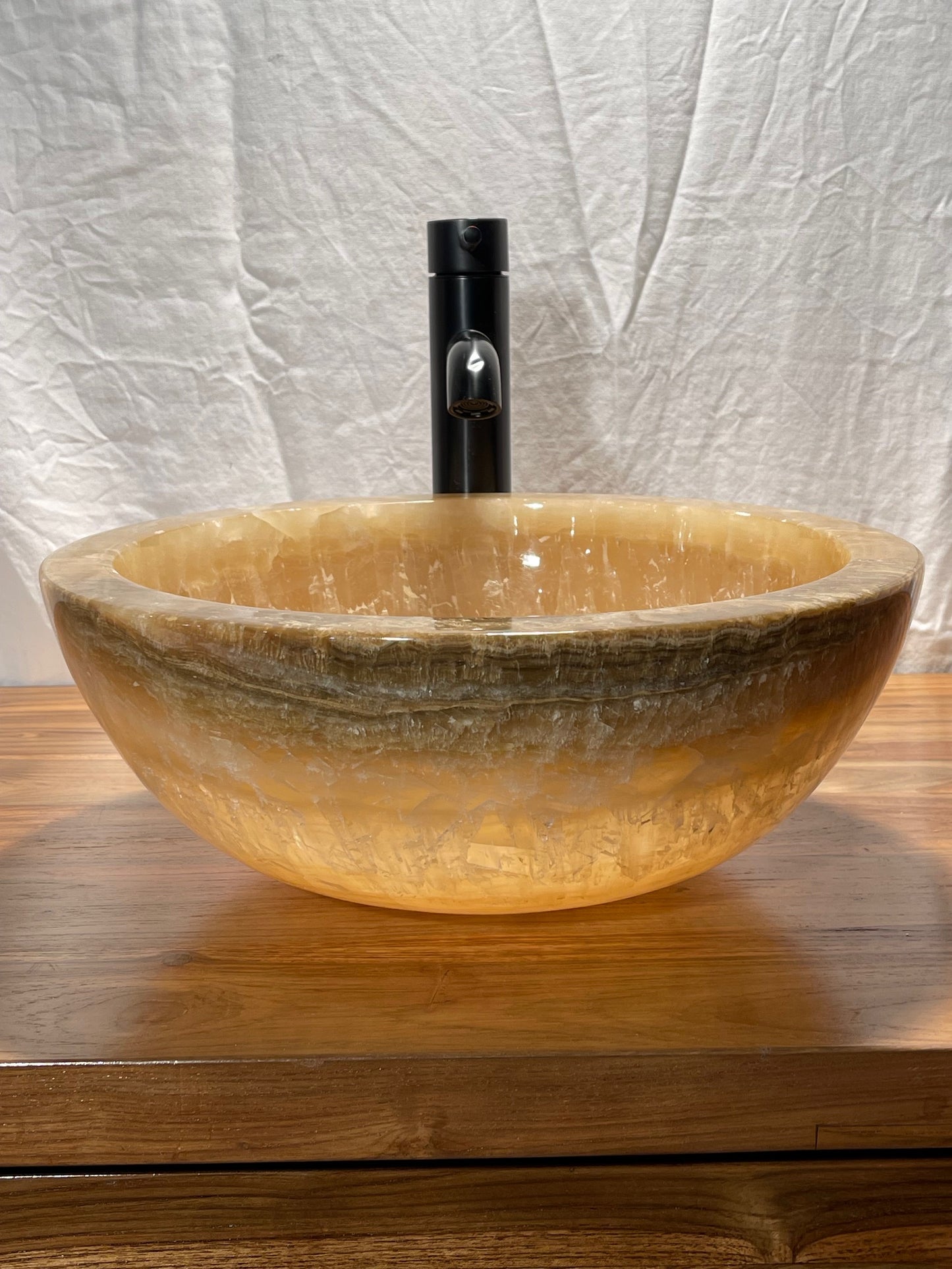 dark honey onyx natural stone vessel sink bowl at impact imports of Boise, Idaho