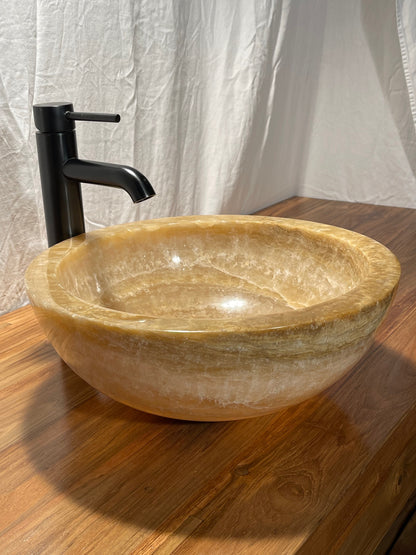 dark honey onyx natural stone vessel sink bowl at impact imports of Boise, Idaho