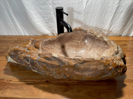 Log shaped petrified wood stone vessel sink at impact imports of Boise, Idaho