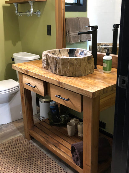 petrified wood stone vessel sink on reclaimed teak vanity installed at Tamarack Idaho