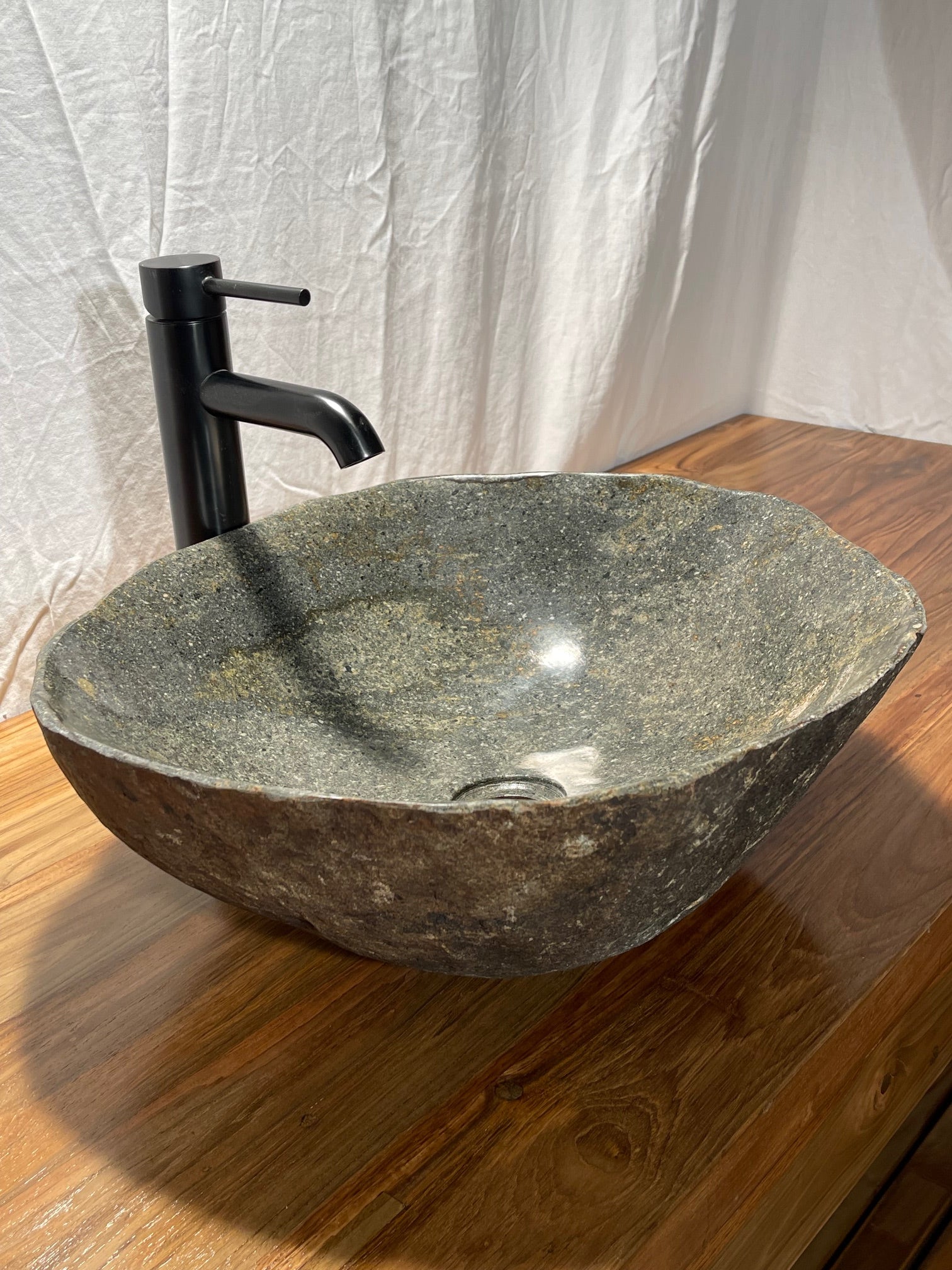 hand cut and polished river rock boulder natural stone vessel sink at impact imports in Boise, Idaho