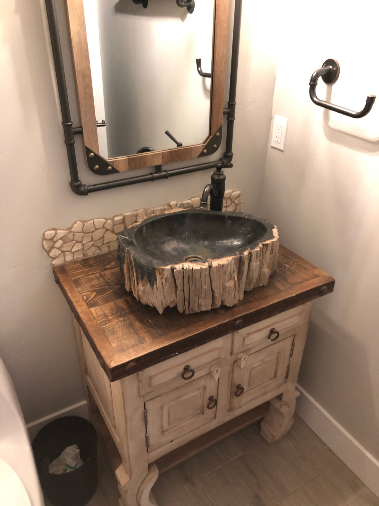 petrified wood stone vessel sink on reclaimed teak vanity installed at McCall Idaho
