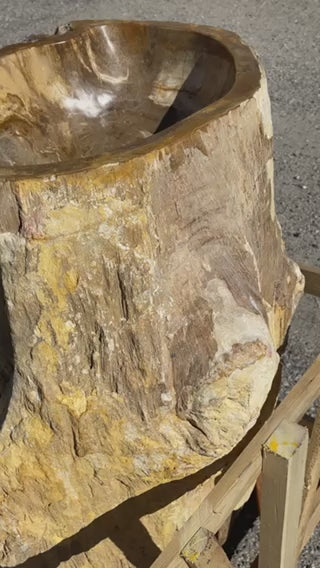 brown colored petrified wood stone pedestal sink with 3 knots around the body.  located at impact imports in boise, idaho